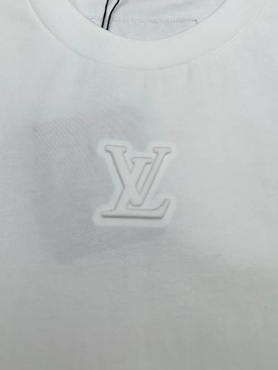 View 3 of Minimalist White Cotton Tee with Embossed Accent, Everyday Luxury