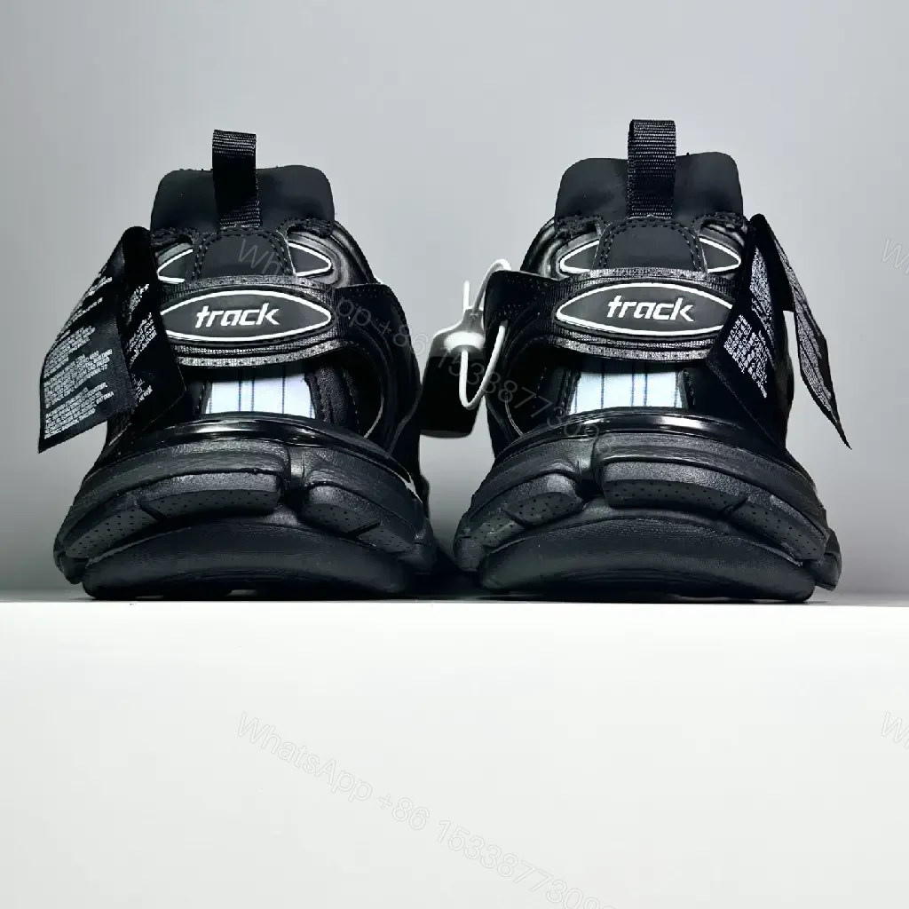 View 2 of black leather and mesh sneakers with logo motif for luxury streetwear