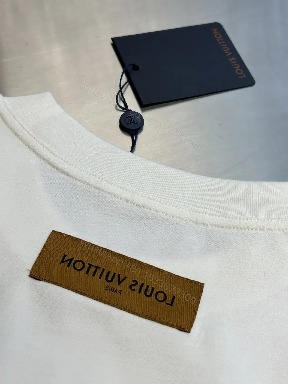 View 9 of Oversized White Tee with Subtle Embossed Logo - Minimal Luxury
