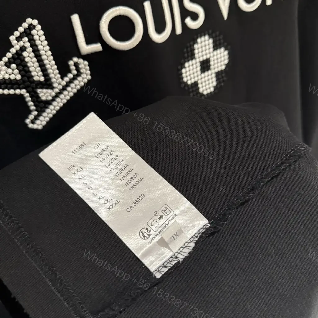 View 2 of Oversized Black Knit Tee, Luxury Crest Embroidery, Casual Comfort