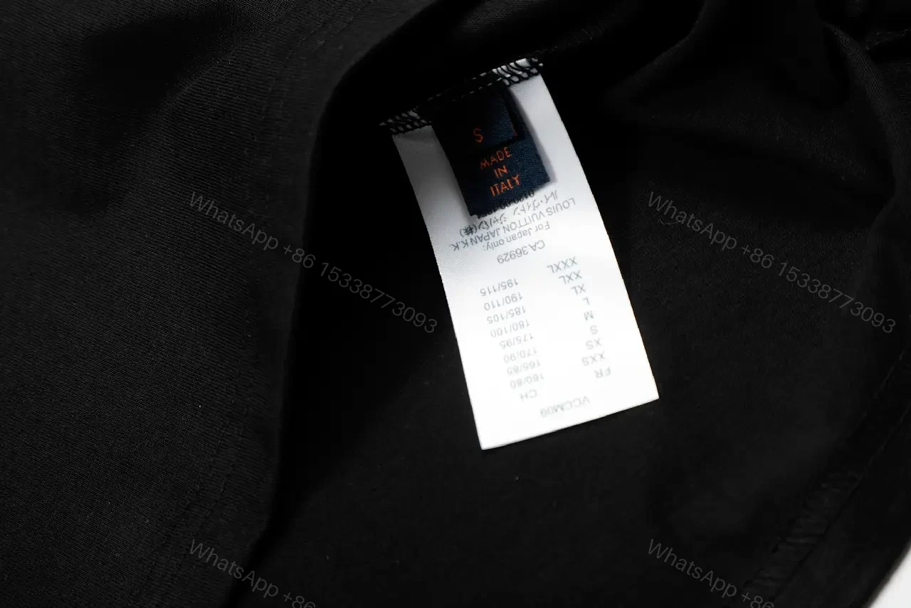 View 5 of Minimalist Black Cotton Tee with Subtle Monogram Detail - Everyday Luxury
