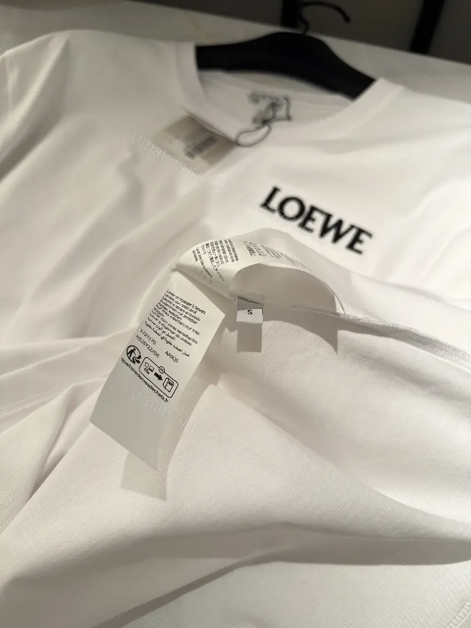 View 7 of Minimalist White Tee with Structured Pocket & Logo Emblem