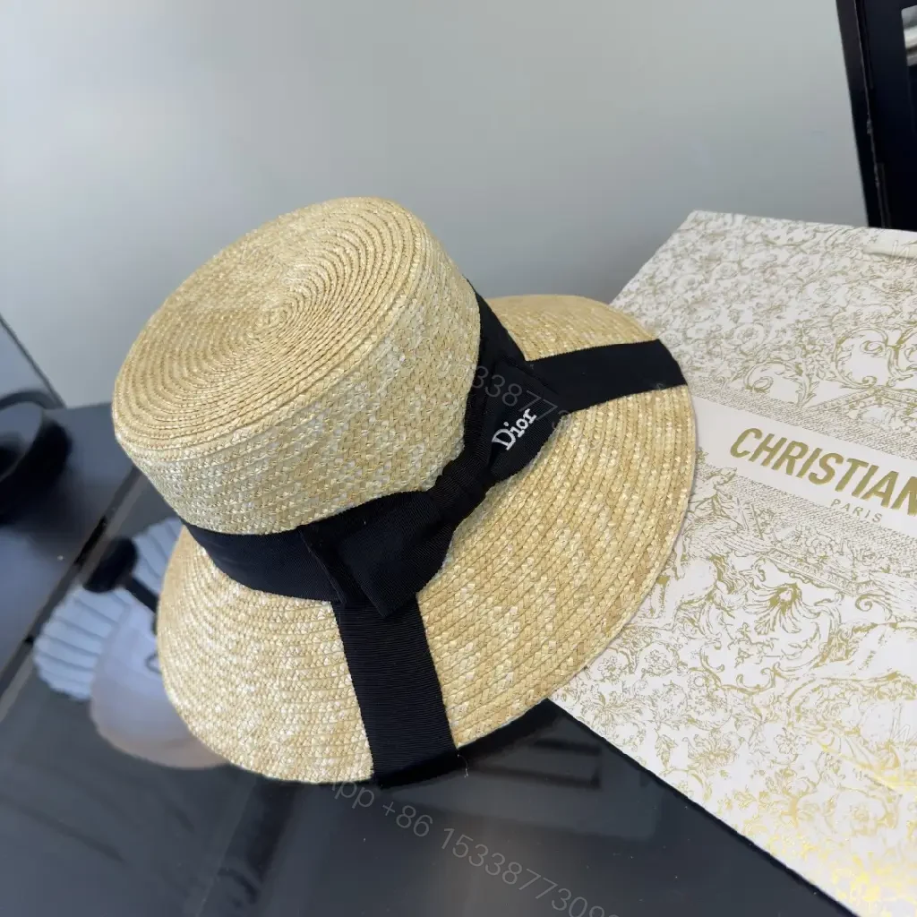 View 5 of Natural Straw Wide-Brim Hat with Black Ribbon Accent
