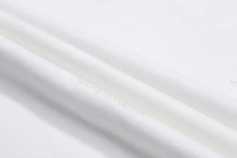 View 10 of Minimalist White Tee: Premium Cotton, Subtle Logo, Everyday Luxury