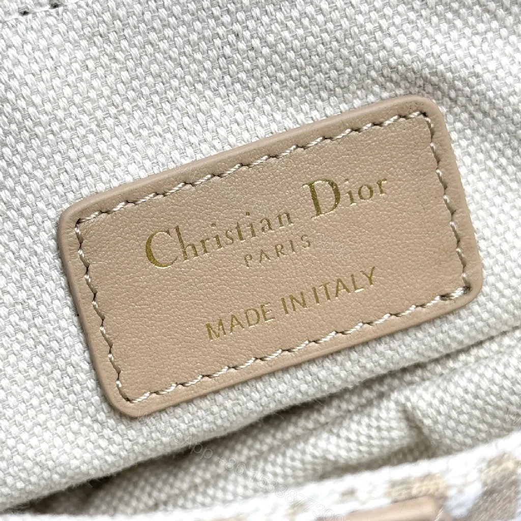 View 9 of Beige Leather-Trim Mini Saddle Bag, Monogram Canvas, Crossbody