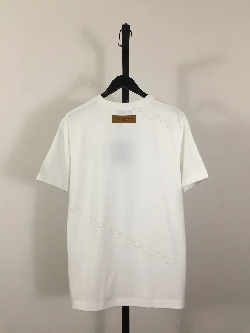 View 5 of Classic White Tee - Premium Cotton, Subtle Emblem, Everyday Luxe