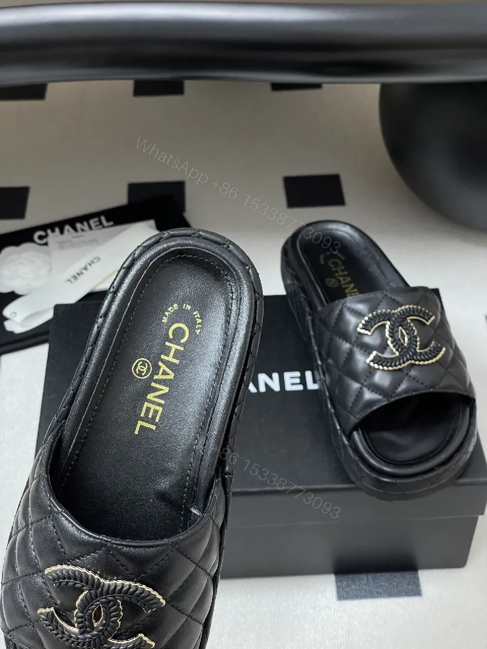 View 3 of Quilted Black Slip-Ons with Gold Emblem – Luxe Style