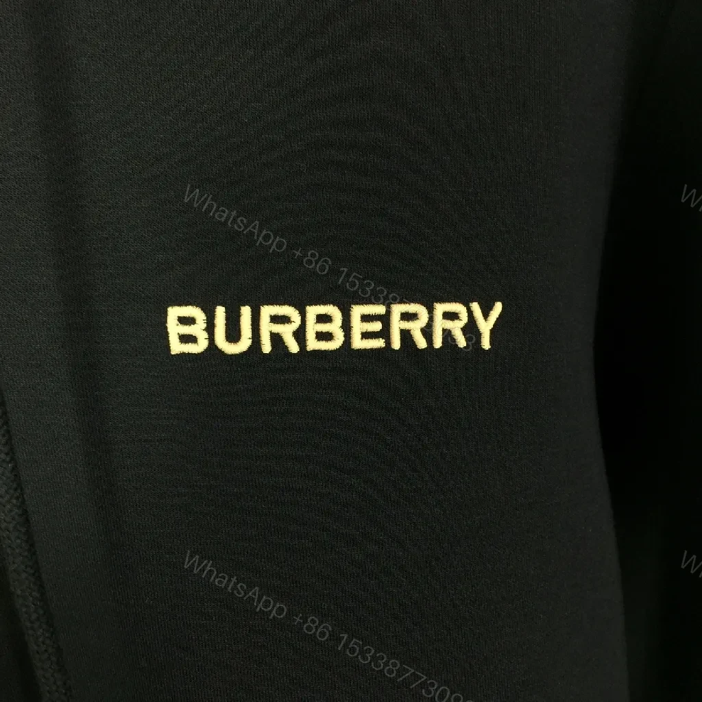 View 3 of Minimalist Black Hoodie with Gold Logo – Premium Casual Wear