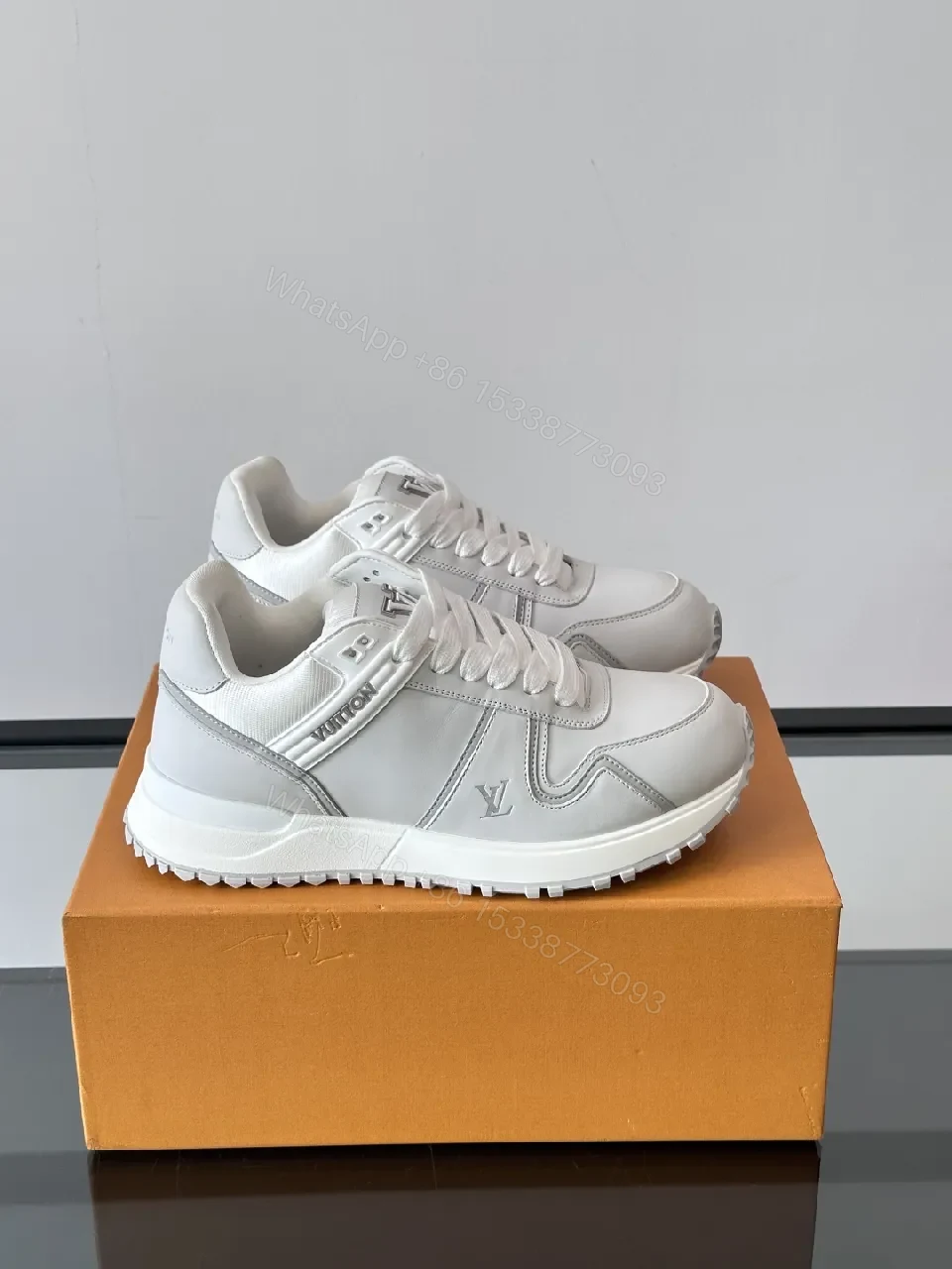 View 6 of Minimalistic White Leather Sneakers with Subtle Texture and Monogram Accent