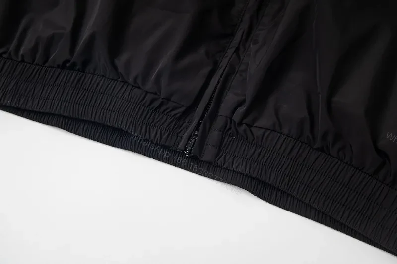 View 7 of Minimalist Black Windbreaker: Subtle Branding, All-Season Outerwear
