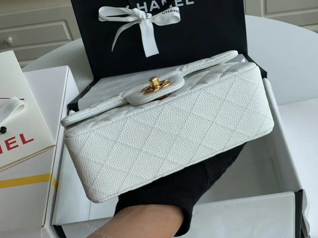 View 4 of Quilted White Flap Bag with Gold Hardware—Compact Elegance