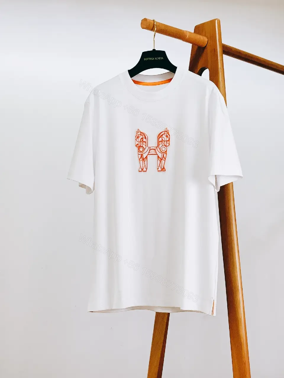 View 8 of Minimalist White Tee with Bold Orange Emblem T-Shirt