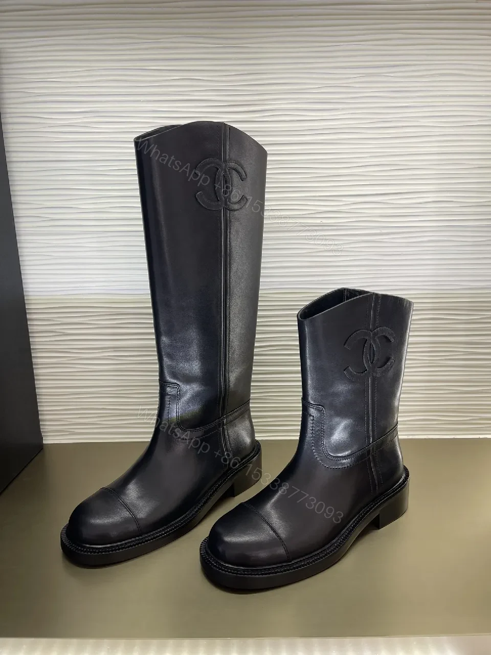 View 8 of Chic Black Leather Knee-High Boots with Logo Embellishment