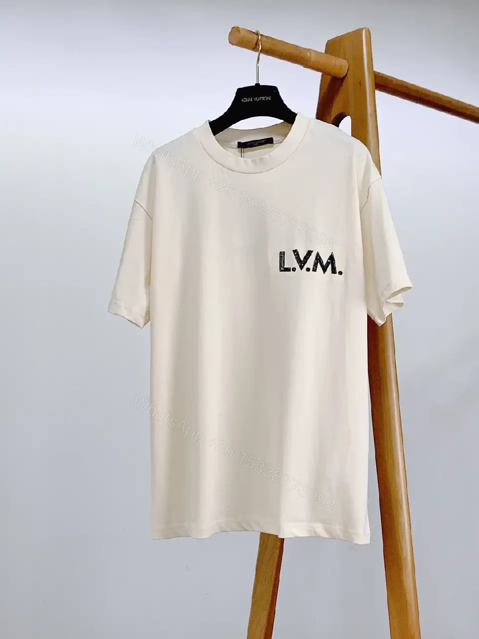 View 5 of Minimalist Off-White Cotton Tee with Signature L.V.M. Accent