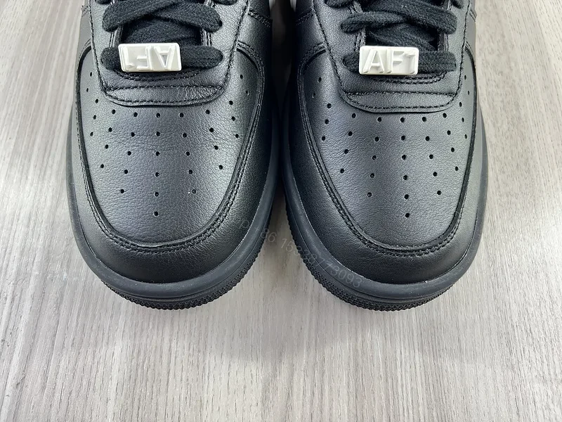View 2 of Black Leather Low-Top Sneakers with White Swoosh - Luxury Streetwear