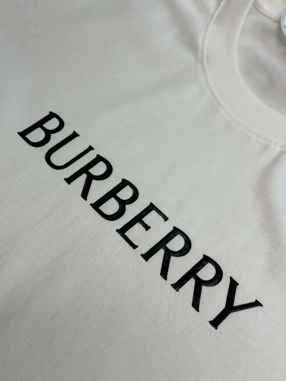 View 2 of Minimalist Burberry-Style White Cotton Tee: Elevated Everyday Comfort