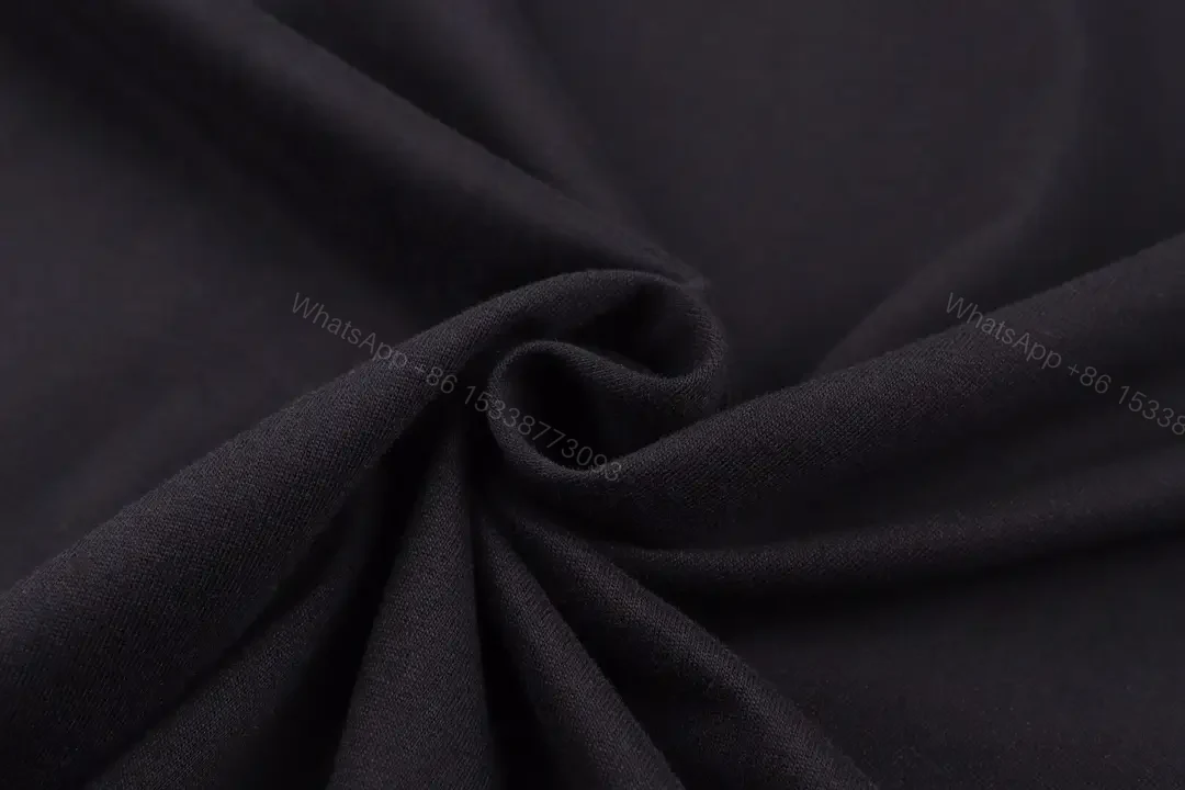 View 4 of Matte Black Cotton Tee with Subtle Embossed Logo, Modern Comfort