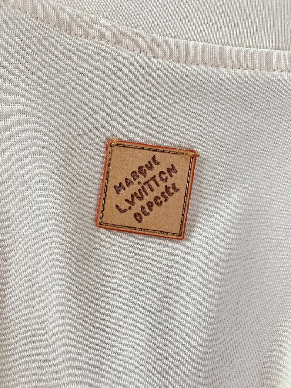 View 6 of Minimalist Off-White Cotton Tee with Signature L.V.M. Accent