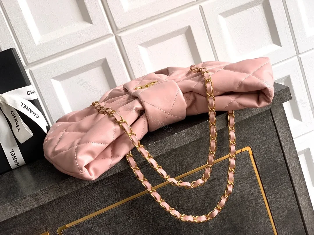 View 2 of Soft Pink Quilted Handbag with Gold Accents, Compact Luxury Tote