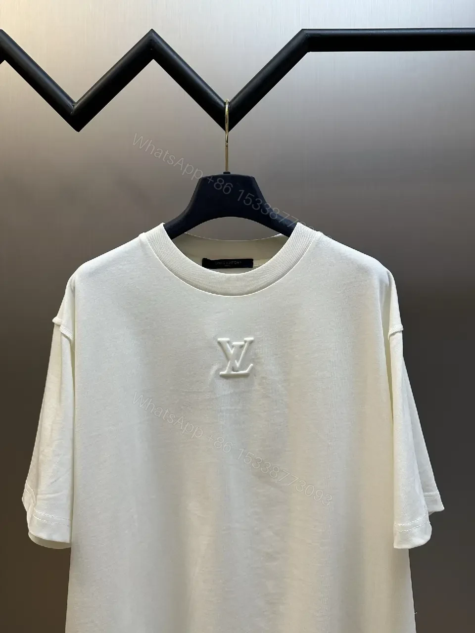View 4 of Oversized White Tee with Subtle Embossed Logo - Minimal Luxury