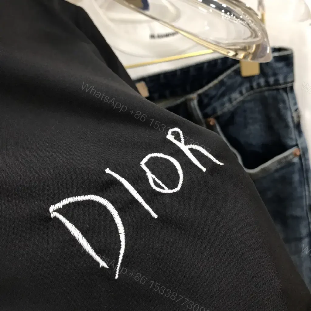View 7 of Minimal Black Shirt Jacket with Subtle Logo Button Front
