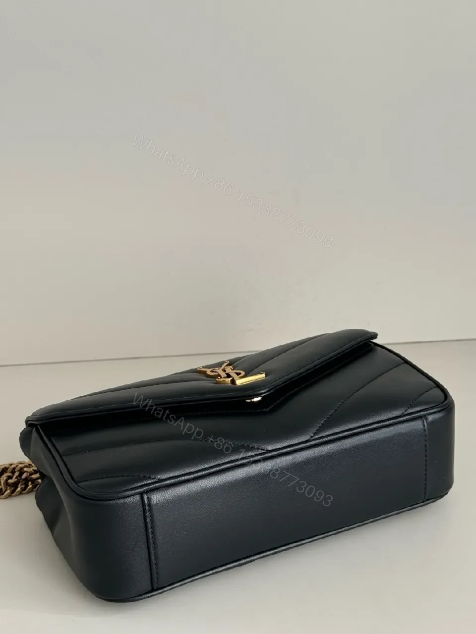 View 2 of Quilted Leather Crossbody Bag with Gold Emblem, Luxury Style