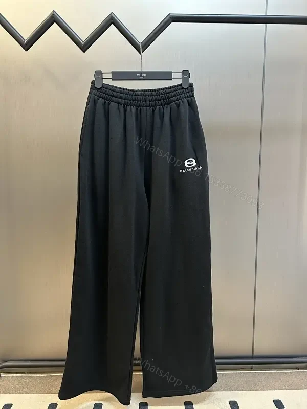 Chic Black Wide-Leg Track Pants with Subtle Logo — view 1