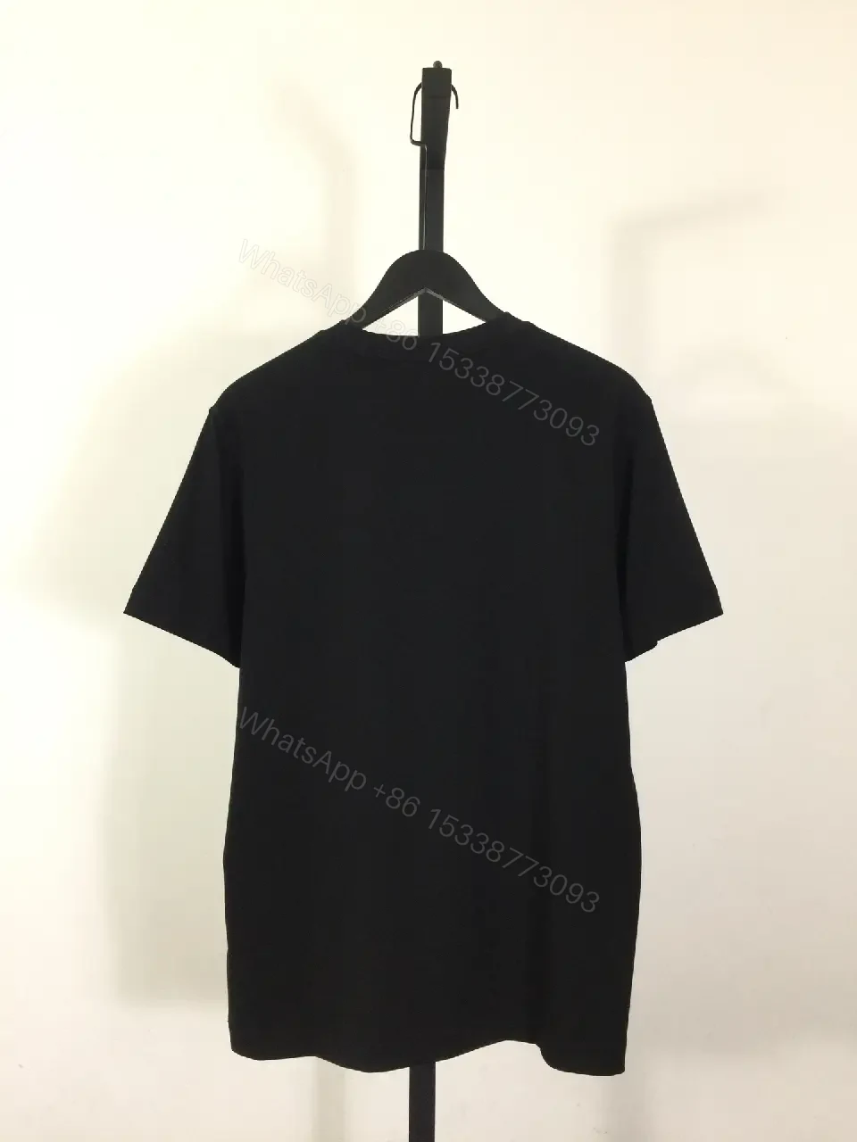 View 7 of Minimalist Black Cotton Tee, Subtle Logo, Everyday Comfort