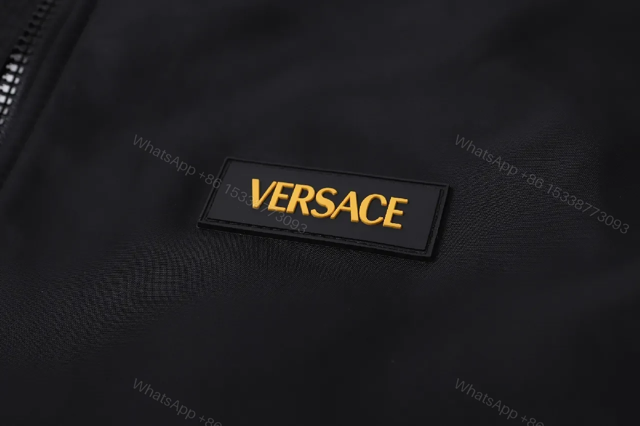 View 6 of Minimalist Black Bomber with Gold Accent: Modern Luxury Outerwear
