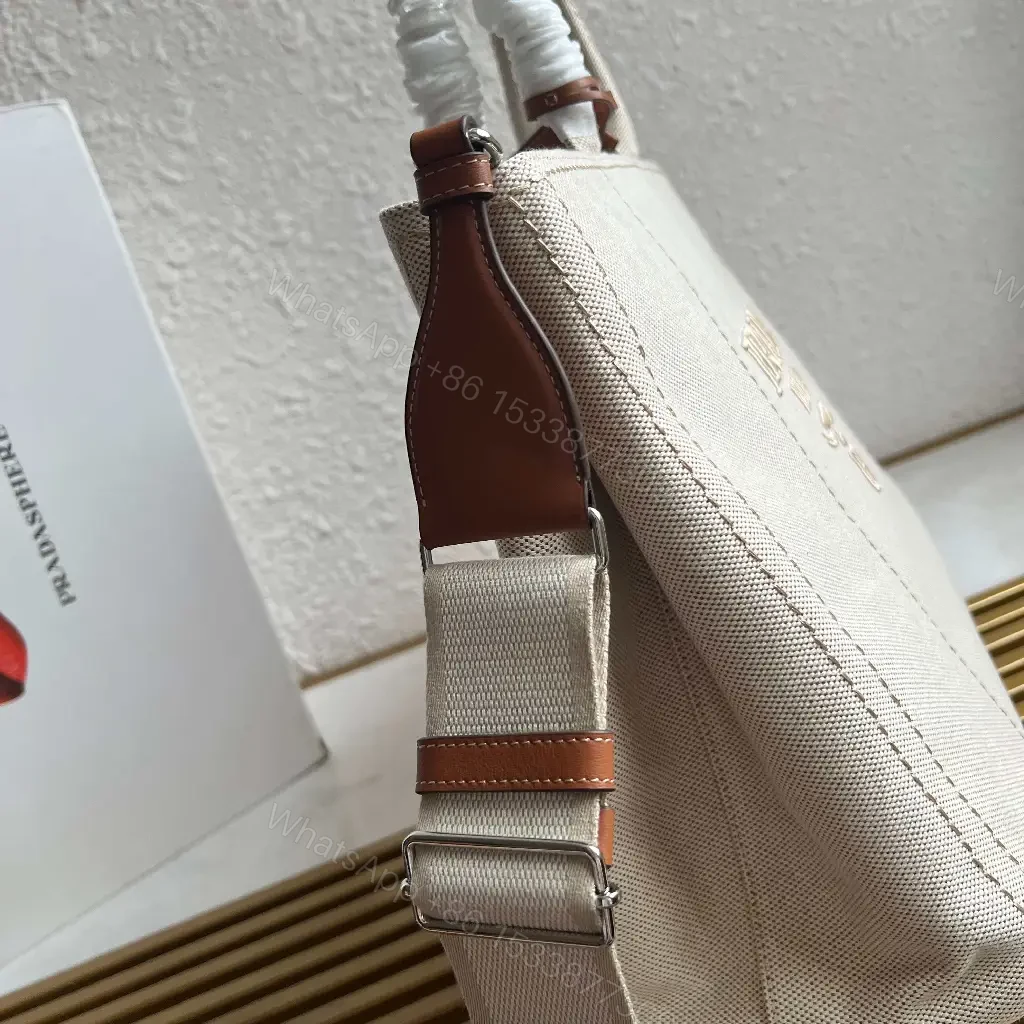 View 2 of Light Beige Canvas Tote Bag with Leather Accents and Structured Silhouette