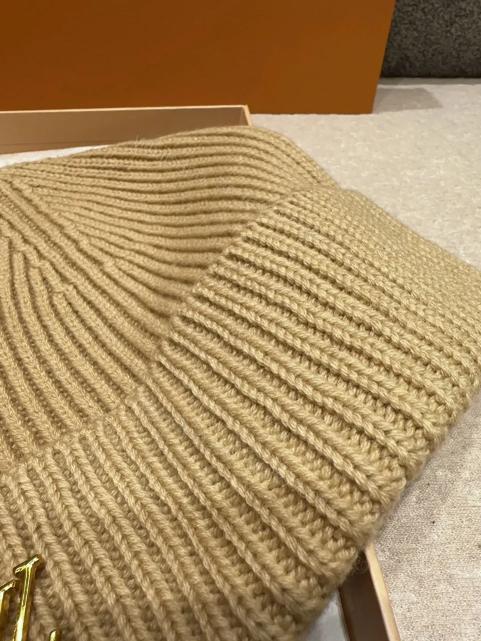 View 6 of Textured Camel Knit Beanie with Gold Crest - Cozy Luxury Style