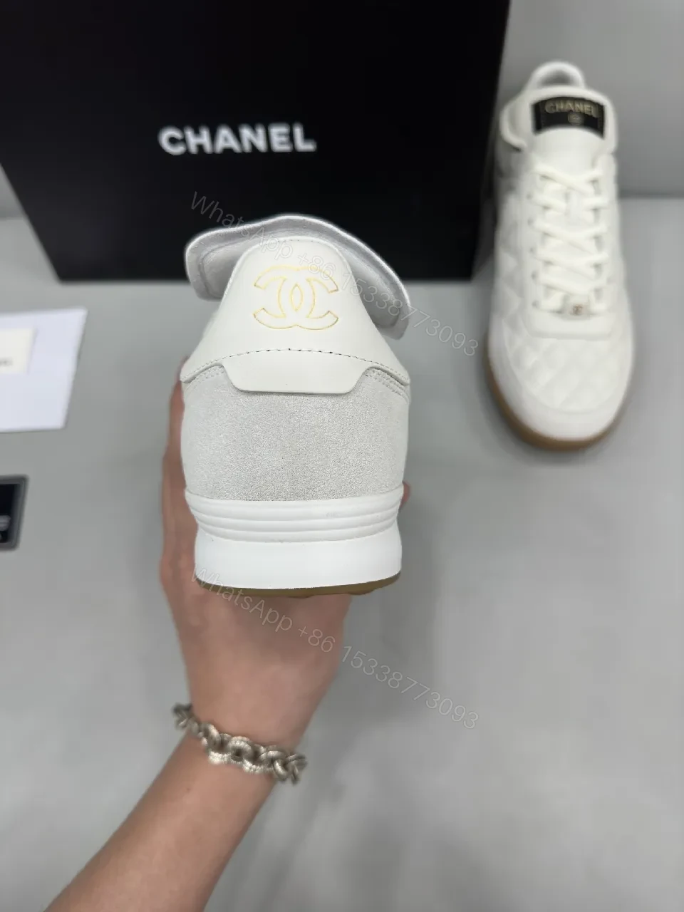 View 3 of White Quilted High-Top Leather Sneakers with Signature Details