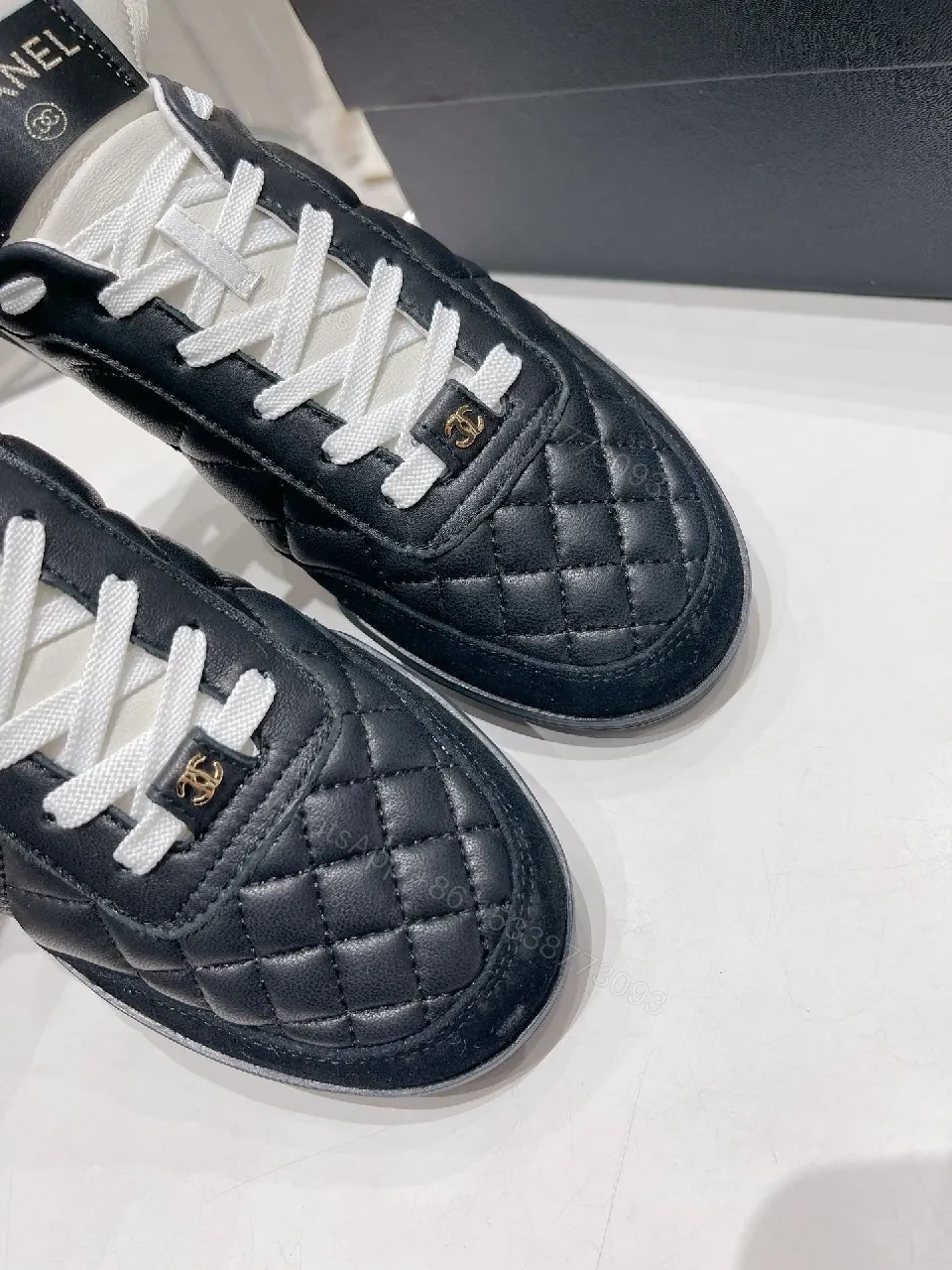 View 5 of Quilted Black Leather Sneakers with Luxe Branding Detail