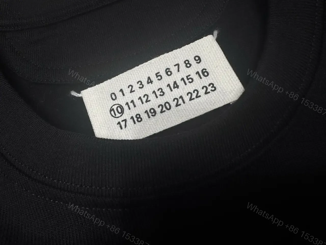 View 5 of Oversized Black Tee with Embossed Numeric Grid - Modern Graphic Comfort