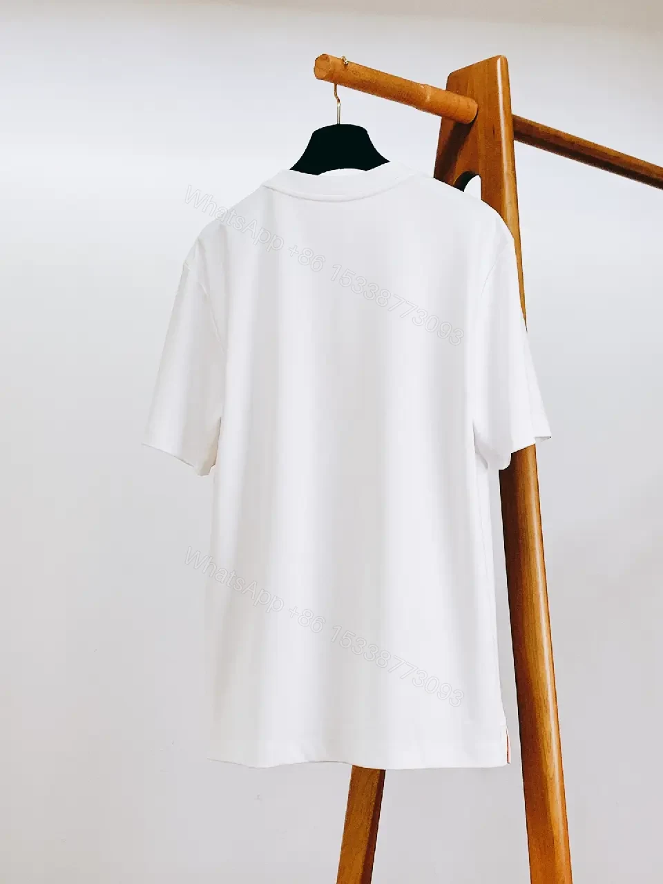 View 10 of Minimalist White Tee with Bold Orange Emblem T-Shirt