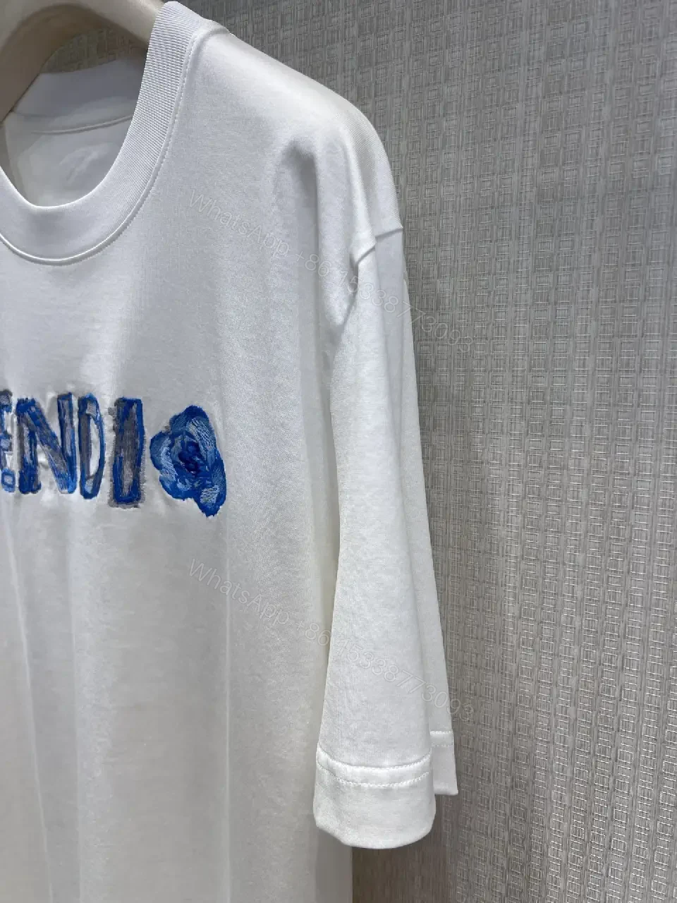 View 7 of Minimalist White Tee with Luxe Embroidered Logo, Casual-Ready Top