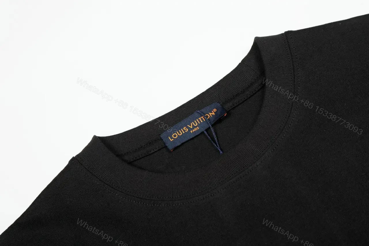 View 8 of Minimalist Black Cotton Tee with Subtle Monogram Detail - Everyday Luxury
