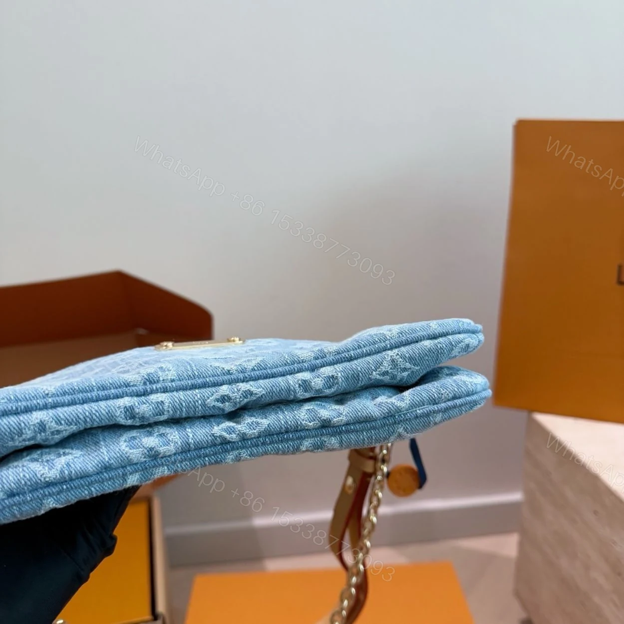 View 9 of Louis Vuitton Liv Pochette Blue Denim 25Cm M83532