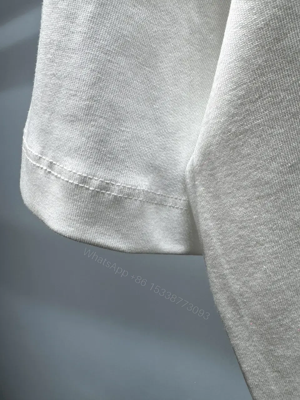 View 5 of Minimalist White T-Shirt with Subtle LV.M Emblem - Premium Cotton
