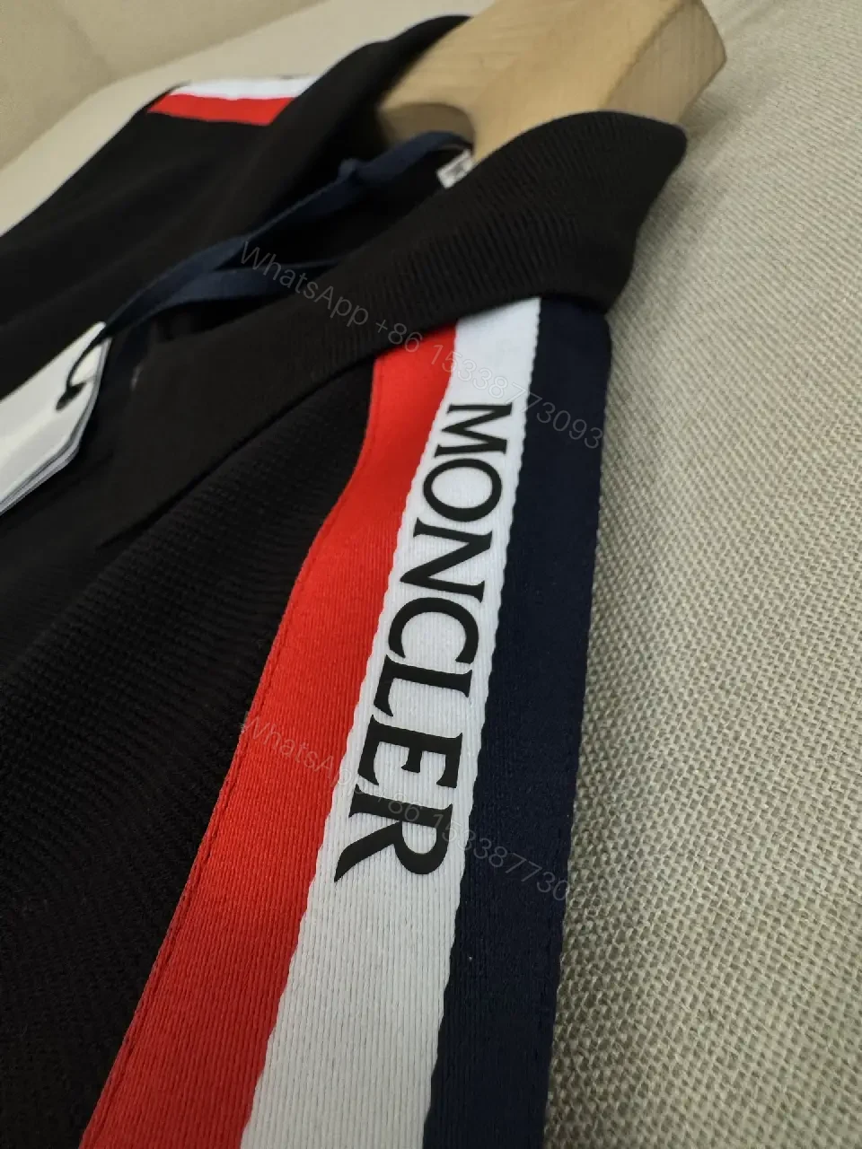 View 8 of Navy cotton polo shirt with red-white striped shoulder accents for everyday luxury