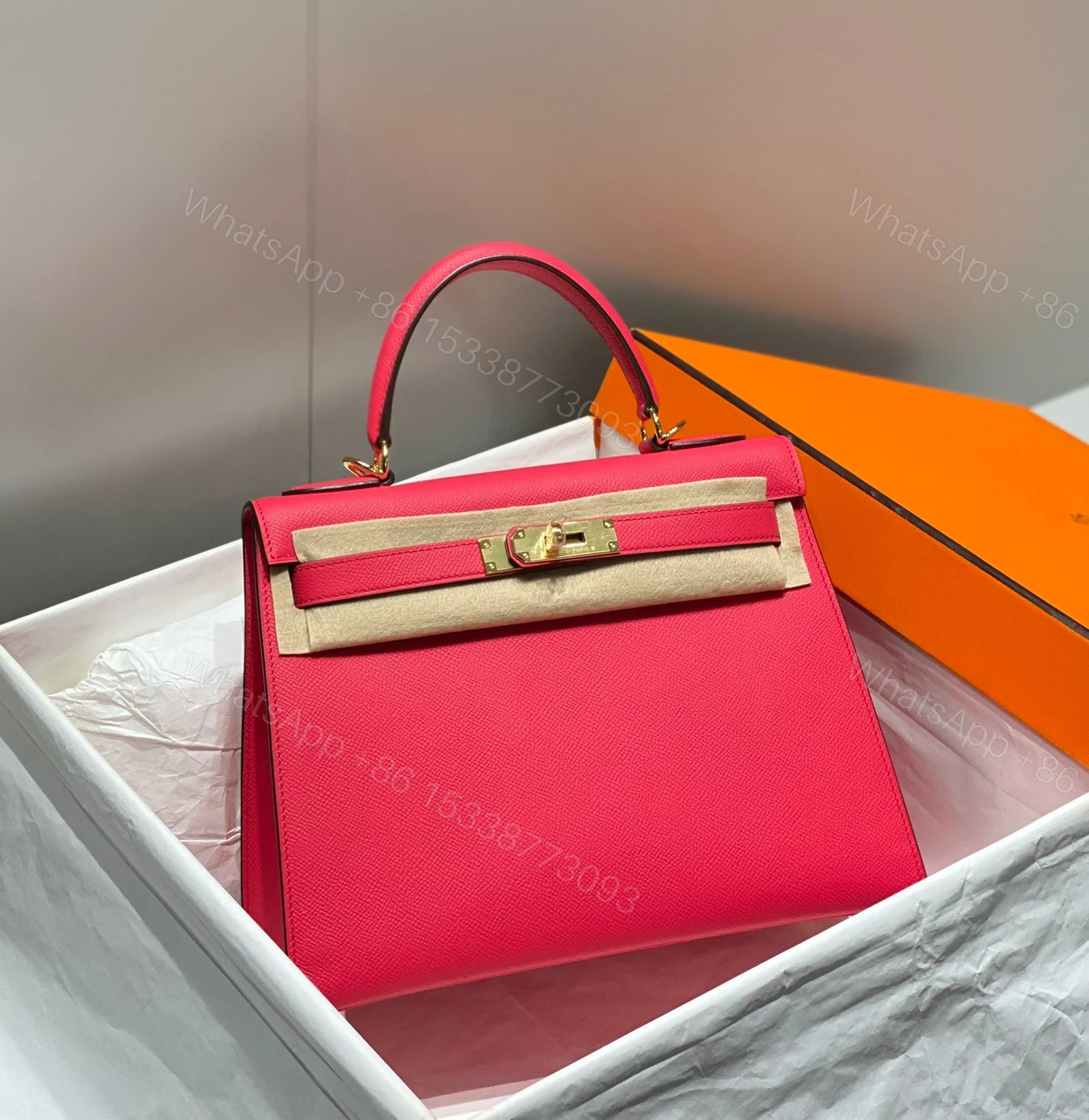View 2 of KELLY 28CM IN ROSE TYRIEN SWIFT CALFSKIN GOLD HARDWARE