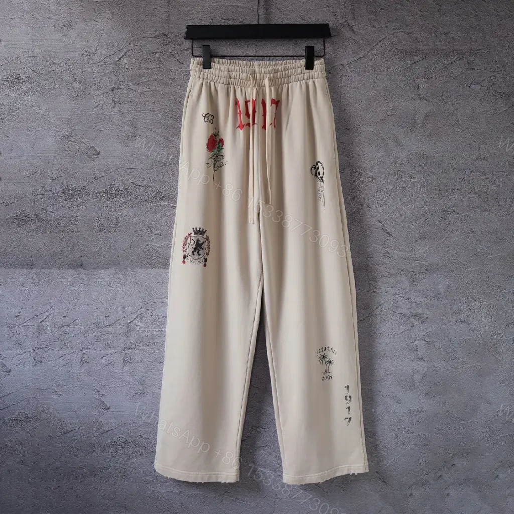 View 2 of Beige Wide-Leg Pants with Drawstring and Embroidered Patches