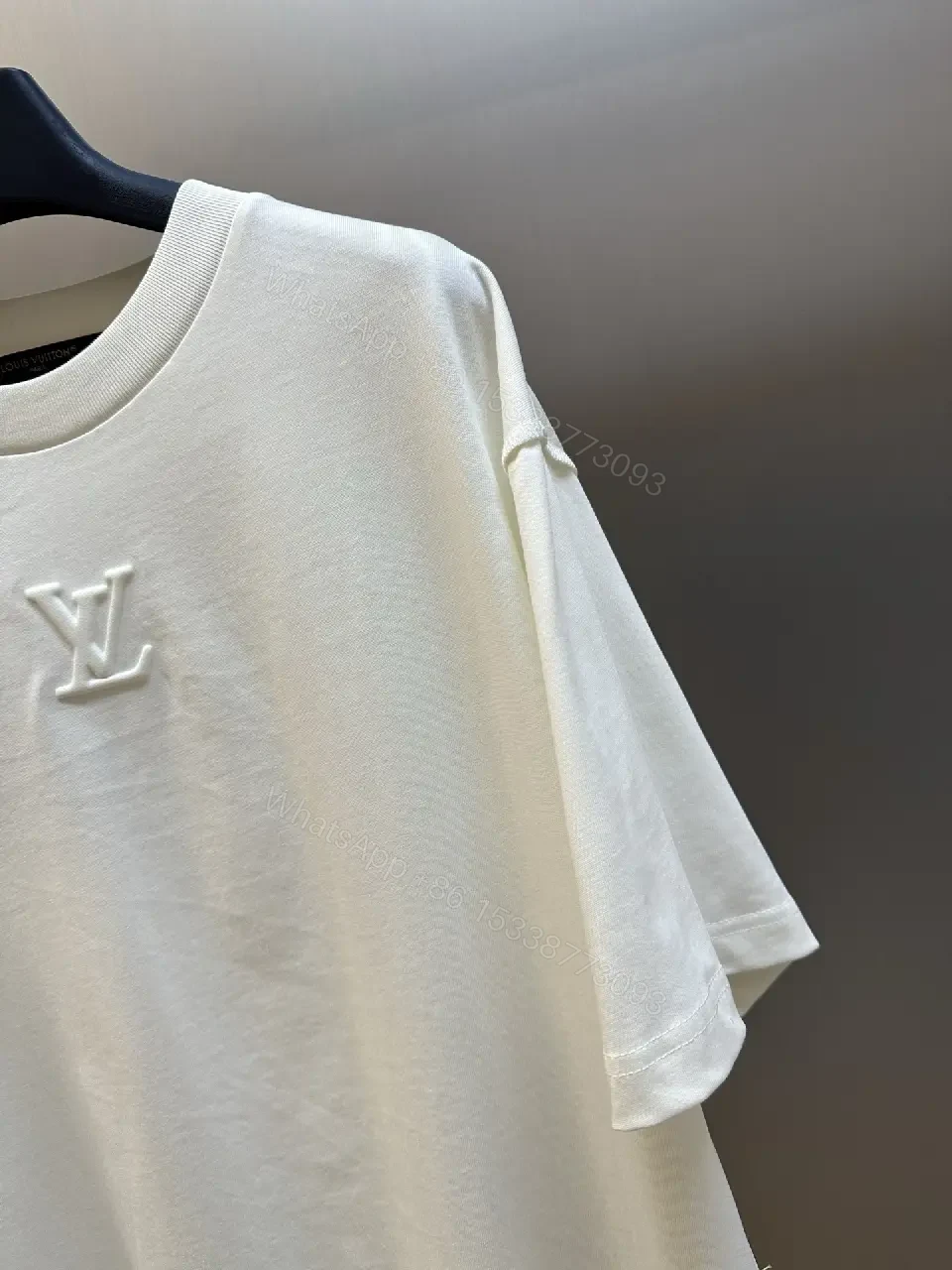 View 8 of Oversized White Tee with Subtle Embossed Logo - Minimal Luxury