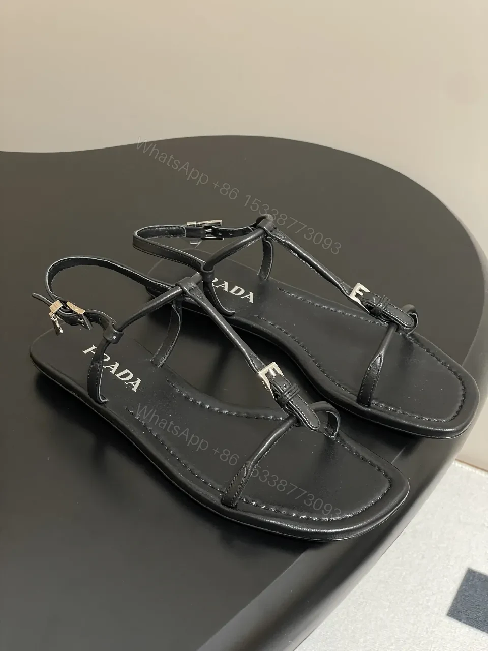 View 6 of Minimal Black Leather T-Strap Sandals with Padded Comfort