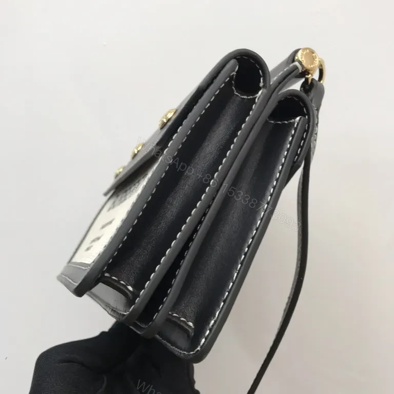View 2 of Beige Canvas & Black Leather Crossbody: Bold Brand Duo