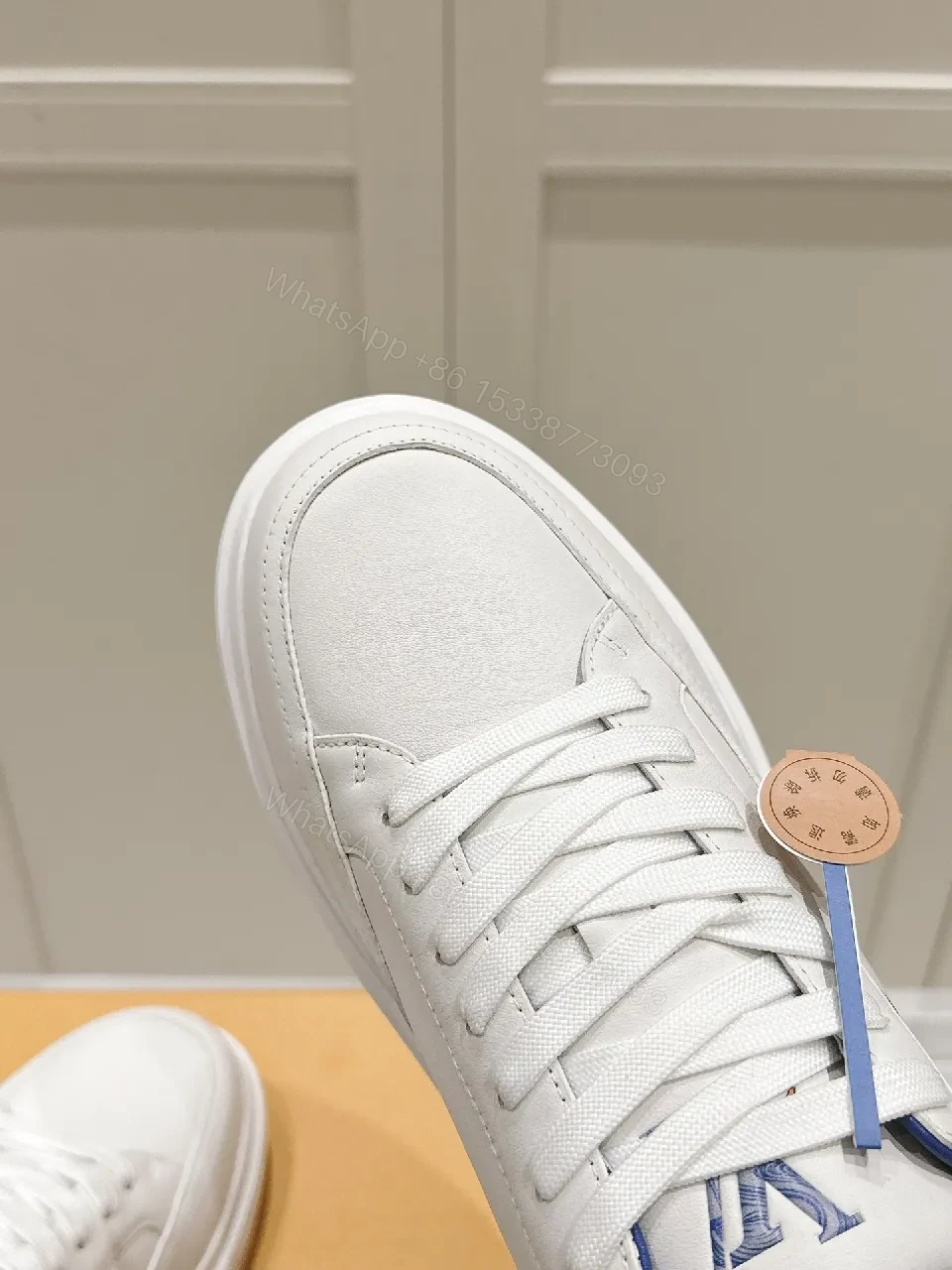 View 5 of Clean White Leather Low-Top Sneakers with Subtle Designer Embellishments