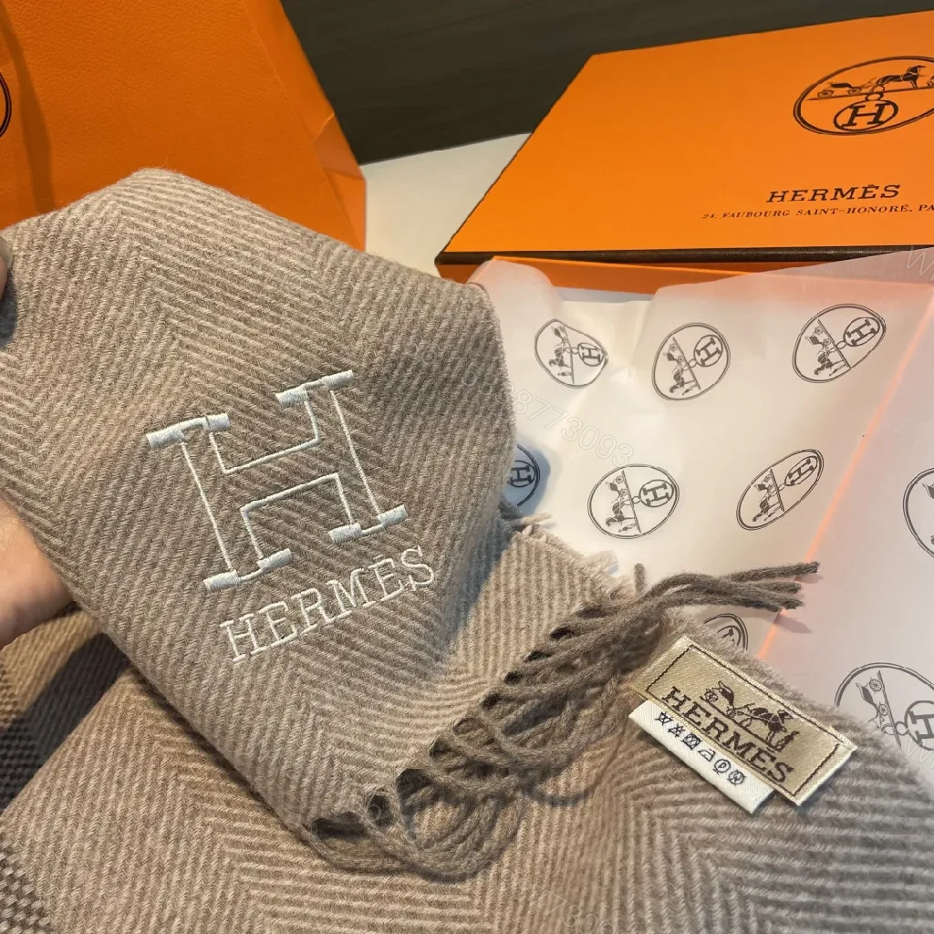 View 6 of Neutral Herringbone Knit Scarf with Subtle Emblem Detail