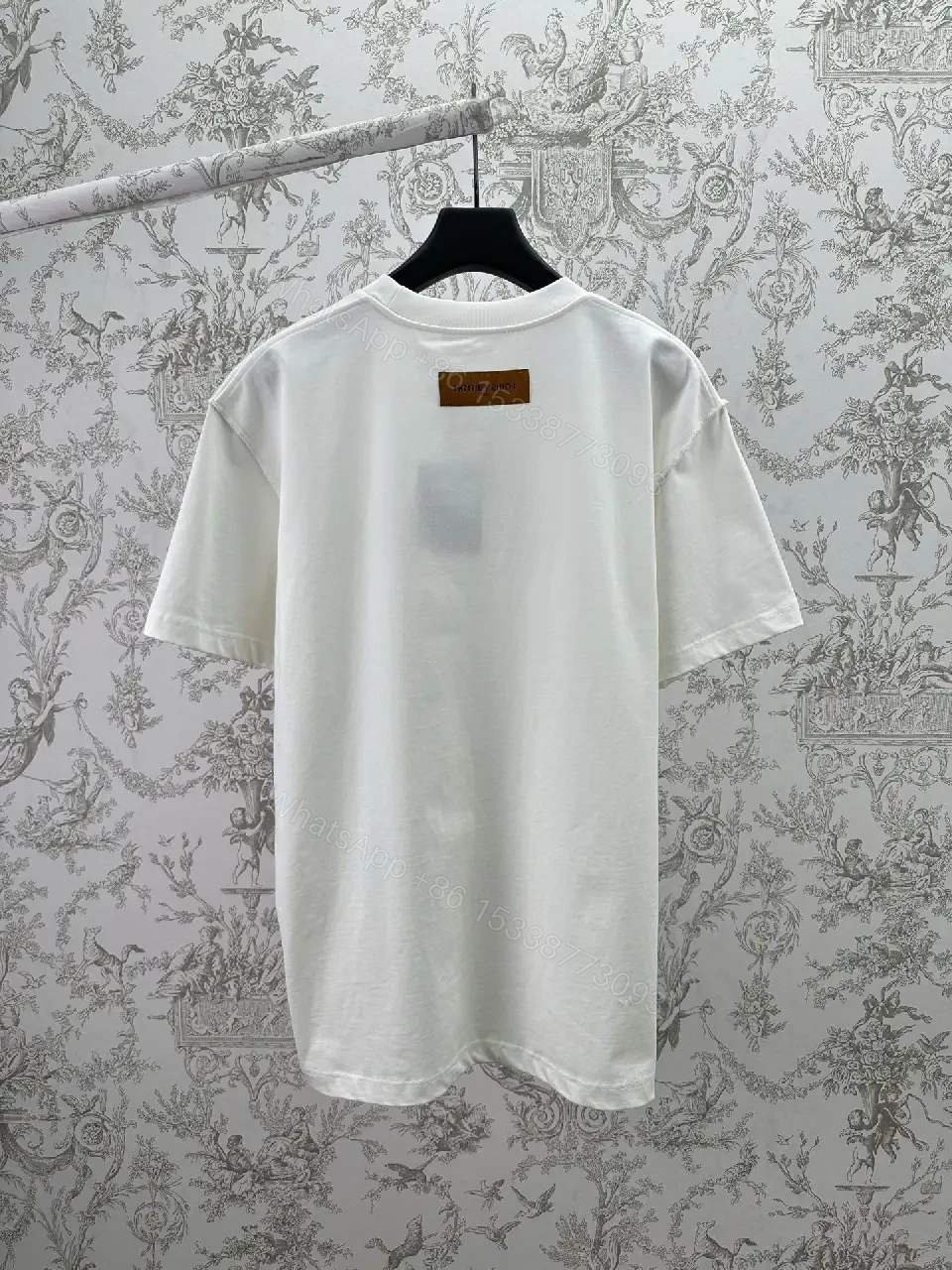 View 11 of Minimalist White Cotton Tee with Embossed Accent, Everyday Luxury