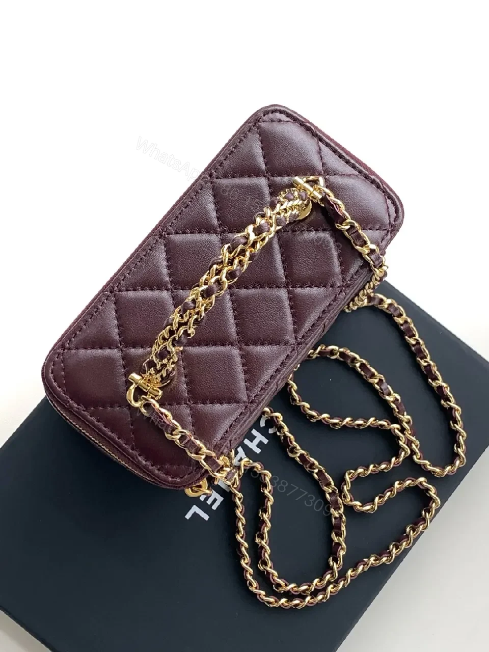 View 9 of Quilted Burgundy Bag with Gold Chain Handle—Compact Luxury