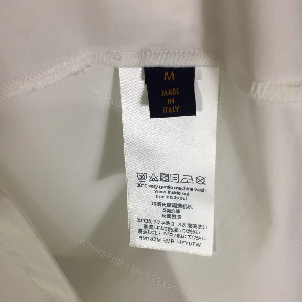 View 6 of Classic White Tee - Premium Cotton, Subtle Emblem, Everyday Luxe